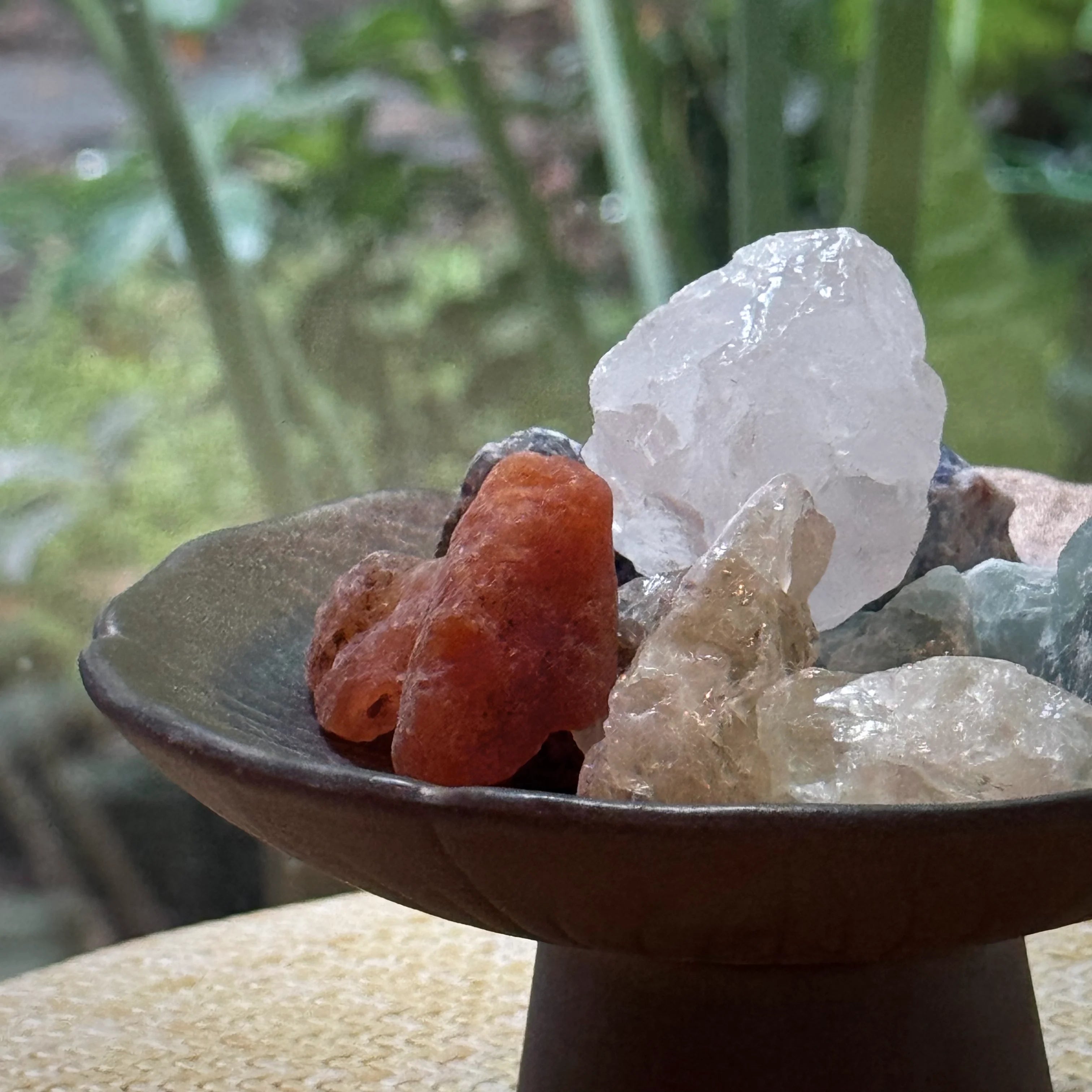 Five Elements energy stones placed on a handmade ceramic dish, creating a sense of feng shui harmony and balanced meditation energy.