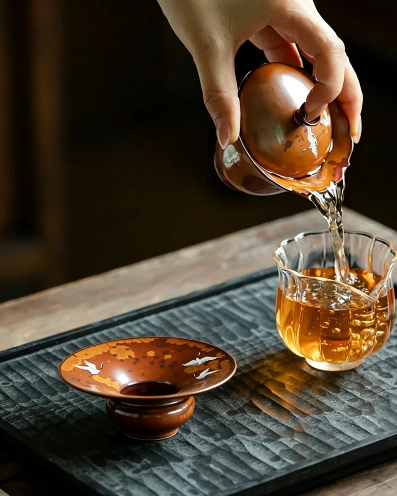 Lifestyle image of Flying Crane ceramic incense holder displayed as home decor on a wooden table, elegant Feng Shui incense burner for peaceful spaces