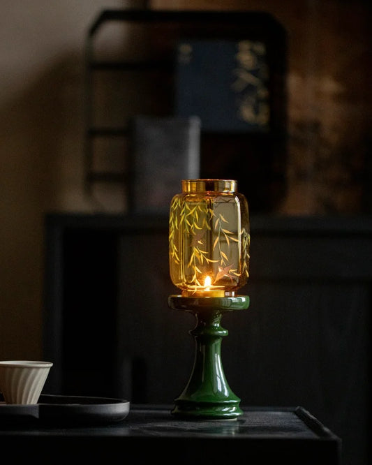Our bifang studio's decorative candle lamp is composed of a green holder and gold top with the pattern that swallows birds by the willow