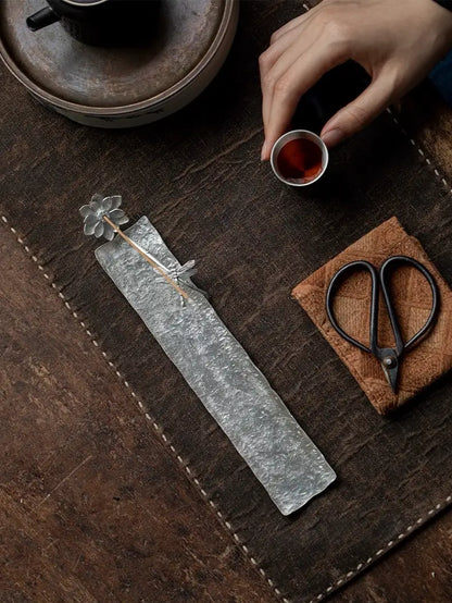 A handcrafted lotus incense holder, delicately shaped with layered petals, perfect for meditation and Feng Shui rituals.