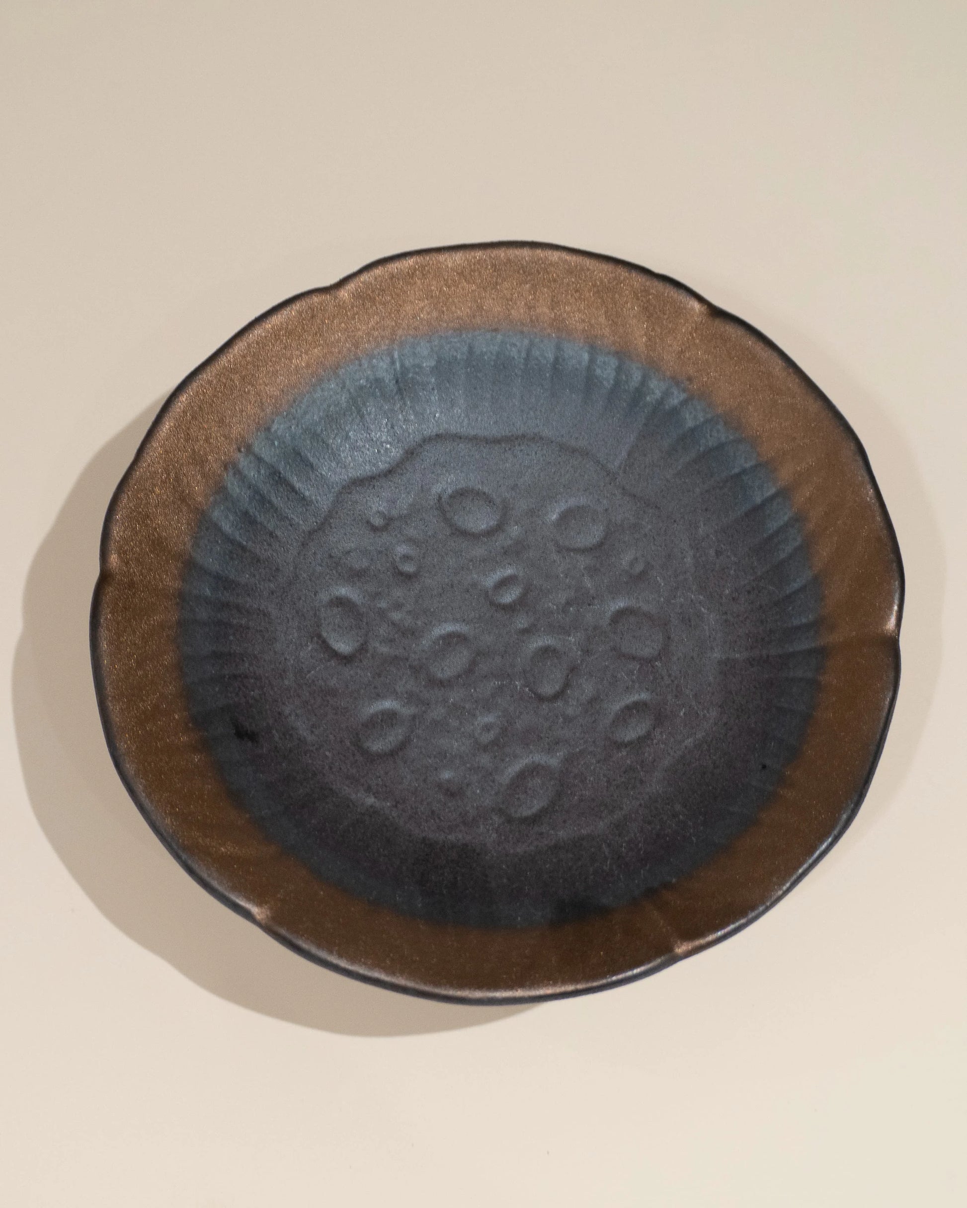 A handmade ceramic dish, creating a sense of feng shui harmony and balanced meditation energy.